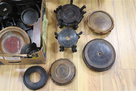 A collection of Chinese carved hardwood stands, plate stands, etc.